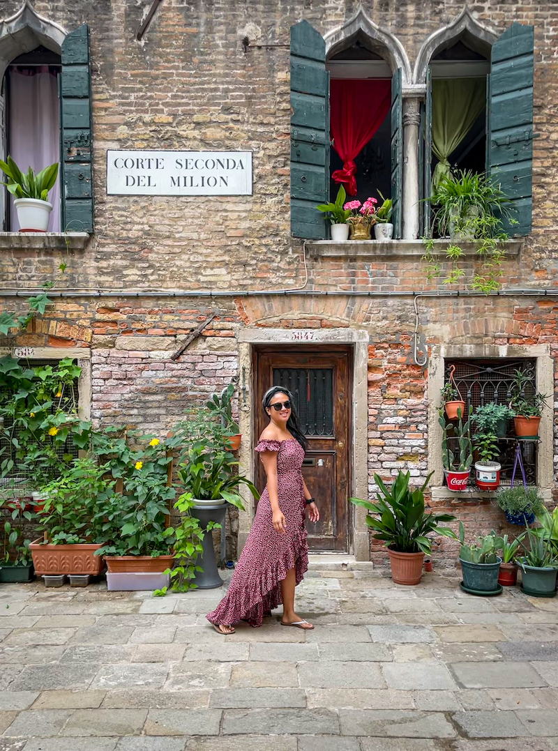 Plant wall in Venice, Italy wearing the Tiare Hawaii Riviera Dress