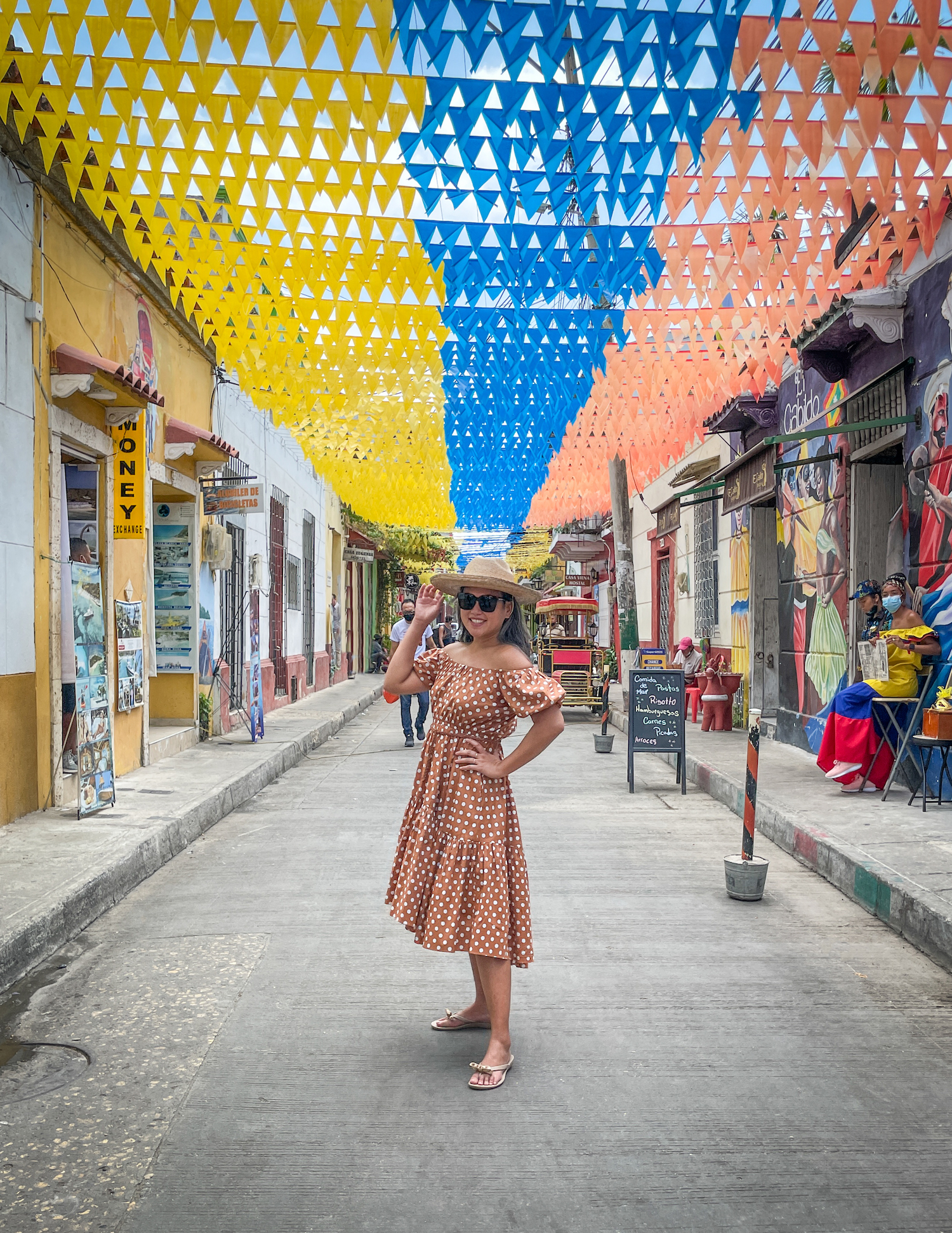 Flag street in Cartagena Colombia Caroline Constas Polka Dot Dress Oka-b Sandals Lack of Color Palma straw Hat