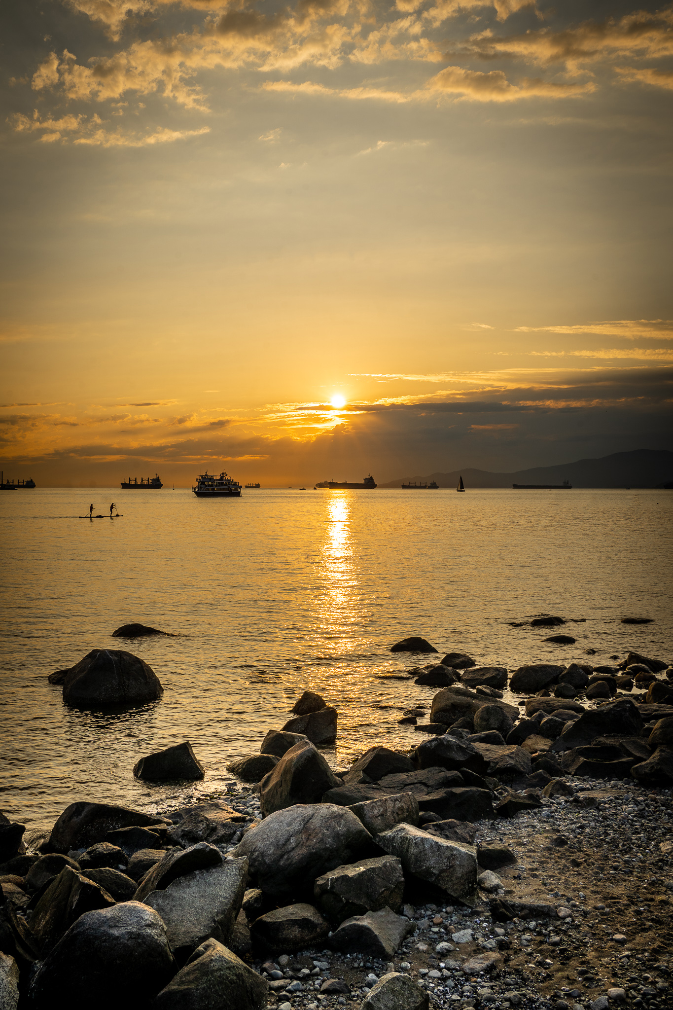 Sunset over English Bay boardwalk Vancouver BC Canada