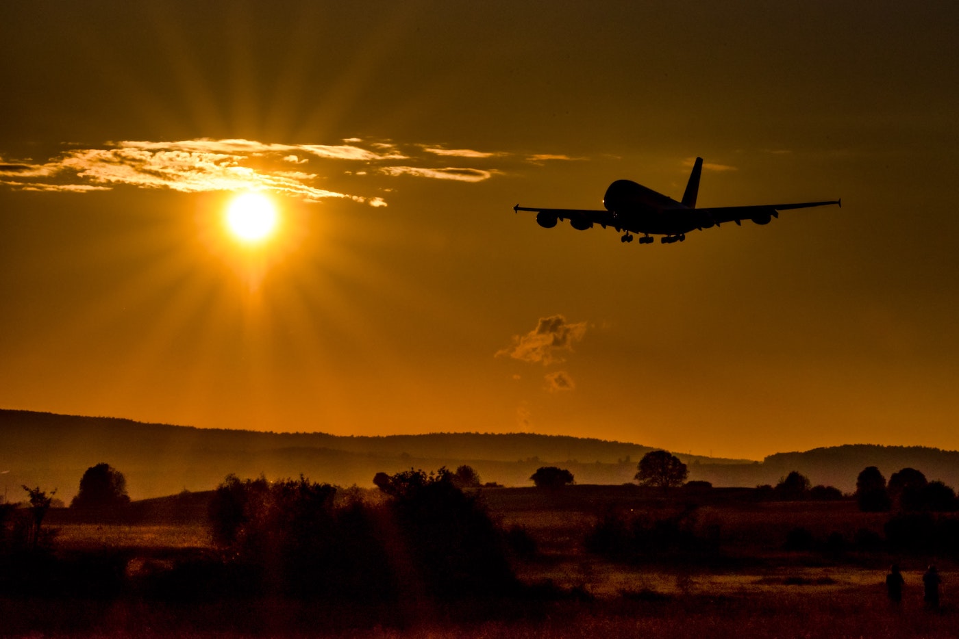 airplane flying during sunset golden hour